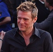 Bryan Adams co-wrote three songs for the 1982 releases Killers and Creatures of the Night. Bryan Adams at 2009 Juno Awards (02) (cropped).jpg