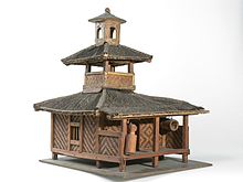Model of a Sundanese mosque with bedug hung horizontally at lower right, front part of the building. To its left a slit drum is hung vertically. COLLECTIE TROPENMUSEUM Model van een Sundanees islamitisch bedehuis TMnr H-247-7.jpg