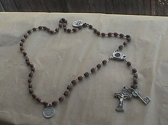 Hand-carved Roman Catholic rosary beads. It has been suggested that the colours of different versions may be connected with the colours of rosary beads. CarvedRosary.JPG