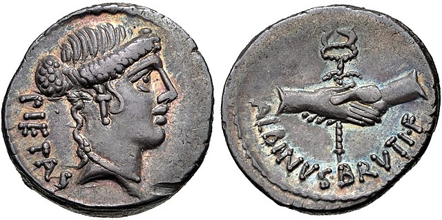 Denarius of Decimus Brutus, minted in 48 BC. The obverse depicts Pietas, while the reverse shows clasped hands around a caduceus, alluding to Julius C