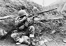 A soldier of the Dutch detachment of the UN forces in North Korea prepares to return sniper fire, 1952 Dutch soldier returns sniper fire in Korea-1952.jpg