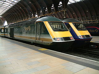 43134 at Paddington, next to two HSTs in the livery of First Group—Great Western Trains' successor