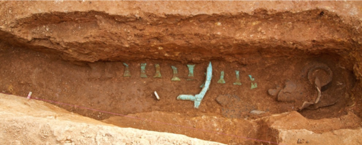 Dagger axe, pots, and copper ingots found at Peun Balo site. GraveDaggerAxe.png