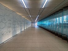 Ground floor corridor at Hackney Wick Station container debossed concrete representations of selected chemical compounds and glass wall representing chemical symbols Ground floor corridor at Hackney Wick Station.jpg