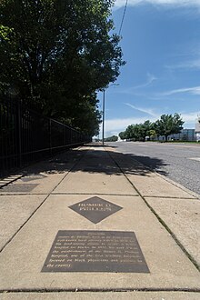 Plaque on sidewalk in St. Louis honoring Phillips