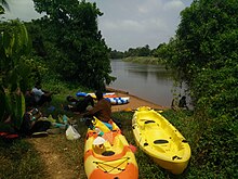 Kayakers taking rest near Palimar dam. Kayakers near river bank.jpg