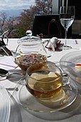 Herbal tea in a glass teapot and cup