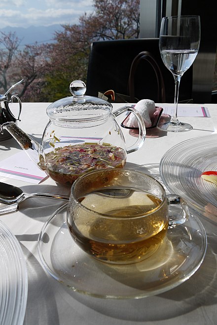 Herbal tea in a glass teapot and cup