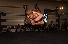 Lio Rush doing Rush Hour finisher at Smash.jpg