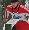 Ski orienteer wearing a map board on a torso harness