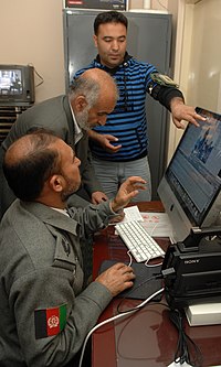 A NATO mentor trains two broadcasters on video editing and storytelling techniques. MOI PA video mentoring (4476152064).jpg