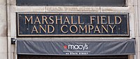 The original State Street entrance sign bronze plaque for Marshall Field and Company with adjacent new Macy's signage, Chicago, 2005