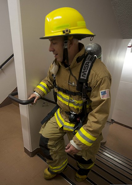 File:Mike Dionne, the Yokosuka chief inspector with Commander, Navy Region Japan, climbs the stairs of a housing tower at Naval Air Facility Atsugi, Japan, Sept 140911-N-OX321-485.jpg