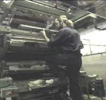 A technician installs a doctor blade for flexographic printing. Mounting doctor blade.jpg
