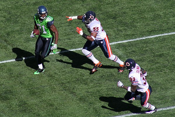 Tillman (bottom right) and Lance Briggs defend Seattle Seahawks receiver Nate Burleson