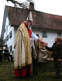Traditional Saint Nicholas during gift-giving to children