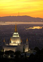 The temple and Oakland at sunset, with San Francisco's Sutro Tower visible in the distance Oakland Mormon Temple3.jpg