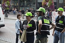 National Lawyers Guild legal observers, in trademark green hats, at a Solidarity Against Hate demonstration in Seattle. Patriot Prayer IMG 4652 (36415338931).jpg