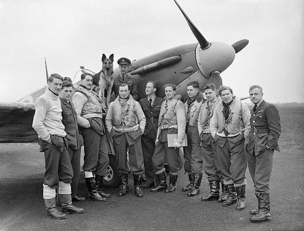 Pilots of 54 Squadron, May 1941 gathered round a Supermarine Spitfire Mark IIA Rochford, Essex. On the wing sits their commanding officer, Squadron Le