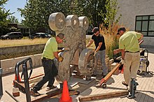 Henry Ford at Delphi (2005) being moved into place in 2012 Positioning (7734423290).jpg