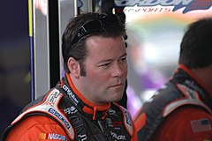 Robby Gordon wearing a dark gray on black subdued Nextel patch when he was sponsored by Cingular when racing for Richard Childress Racing in 2004; Gordon was eventually required to wear full color Nextel Cup logo Robert W. Robbie Gordon photo D Ramey Logan.jpg