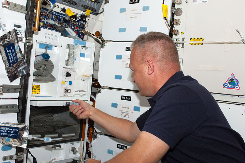 File:STS-135 Doug Hurley prepares a meal at Atlantis' middeck galley.jpg