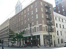 The St. Charles / Rector Hotel Building (seen here in 2007) front and center; a portion of the former Grand Opera House at right. Seattle - 619 Third 01.jpg