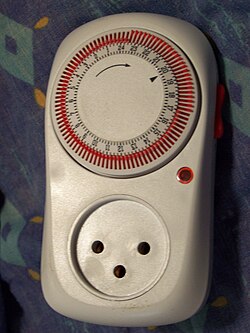 A Shabbat clock. Each orange peg determines its state for one 15-minute interval. This clock is set to turn on a light between approximately 17:00 and 23:30 (the light would be plugged into the 3-prong Israeli socket). Shabbat clock.JPG