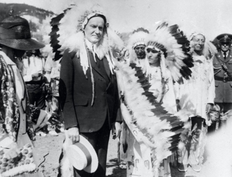 Coolidge visits a Native American tribe while in South Dakota. August 27, 1927. U.S. President Calvin Coolidge, "Chief Leading Eagle", 1927.png