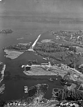 Aerial view of the Evergreen Point Floating Bridge under construction, 1962. This shows the causeway extending from Foster Island in the Washington Park Arboretum roughly east to where Union Bay opens up into Lake Washington. Evergreen Point is across the lake. Washington SR-520 bridge under construction - 1962.jpg