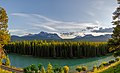 Wide lens shot of railway on the side of a river cutting through deciduous forest in Banff National Park.jpg