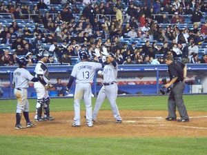 Peña is congratulated by Carl Crawford and Akinori Iwamura after hitting a three-run home run against the Yankees on April 4, 2008