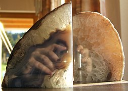 polished agate bookends reflecting photographer's hands