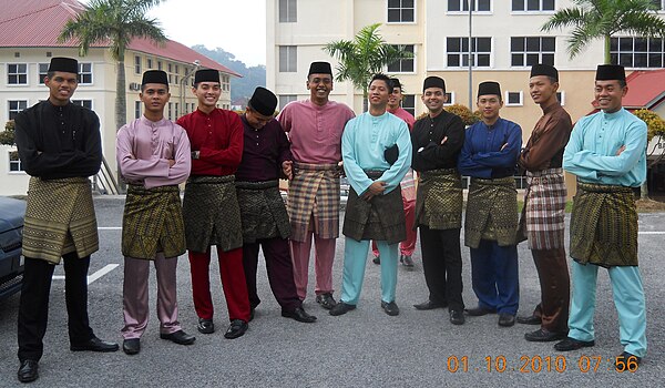 A typical Baju melayu assemble, worn together with the songket. Baju Melayu traces its origin to the 15th century Malacca Sultanate, and today is one 