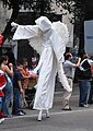 Participant in angel costume and stilts