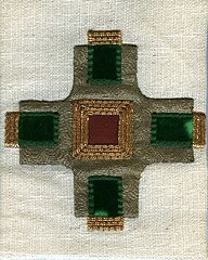 Appliqué cross. The edges are covered and stitches are hidden. It is overlaid with decorative gold thread.