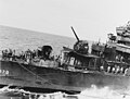 U.S. Destroyer Smith refueling from battleship South Dakota on October 28, 1942. Her two forward 5"/38 guns and much of her forward superstructure are burned out and otherwise damaged, the result of a Japanese torpedo plane that crashed into her two days earlier, during the Battle of the Santa Cruz Islands.