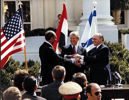 Sadat, Carter and Begin shaking hands after signing Peace treaty between Egypt and Israel in the White House, March 27, 1979