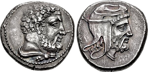 Coin minted by Tiribazus at Mallus in Cilicia. The reverse portrays him wearing a Persian satrapal headdress, while the obverse portrays Herakles