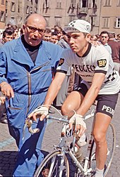 Eddy Merckx being pushed while on bike before a stage.