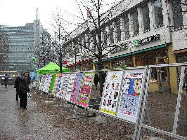 Finnish parliamentary election uses the open list method. Here an official poster rack in central Helsinki displays the candidates and their assigned 