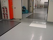 A clean-looking laboratory room with a white mat across a doorway