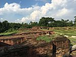 Brick ruins, partially covered by grass