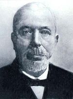 Black and white photograph of elder and bald John Houlding, wearing beard and bow tie.