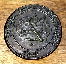 Back side of the same medal. IAMG changed it name from International Association for Mathematical Geology to International Association for Mathematical Geosciences in the 2000s. The medal still shows the old name as a batch of them were crafted before the change. KrumbeinBack2022.jpg