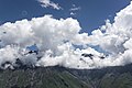 Kuru mountain range, Caucasian mountains of Georgia under white clouds and blue sky.jpg