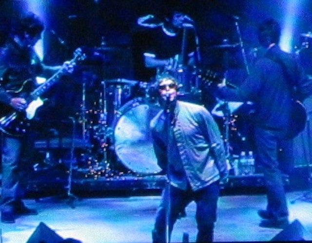 Oasis playing live. NME states, "as (What's the Story) Morning Glory? emerged to colossal sales, it became clear that while Blur had won the battle, O