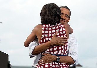 Barack Obama embraces the First Lady after she had introduced him at a 2012 election campaign event in Davenport, Iowa. The campaign tweeted a similar photograph from the campaign photographer on election night and many people thought it was taken on election day. Michelle and Barack Obama embrace.jpg