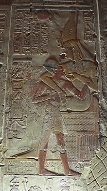 Mut nursing the pharaoh, Seti I, in relief from the second hypostyle hall of Seti's mortuary temple in Abydos. Mut nursing Seti I.jpg