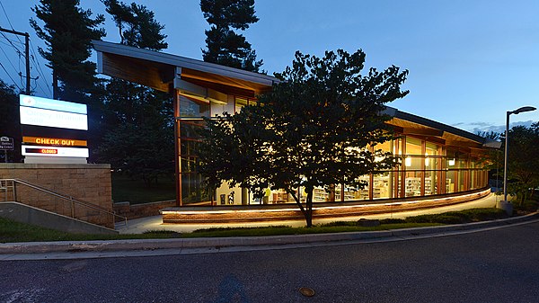 The sign and side of the Olney, MD library in the evening